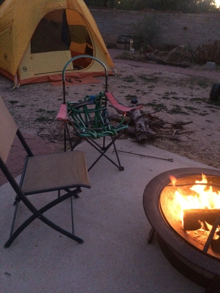 Woven chair next to a raised fire pit and another chair