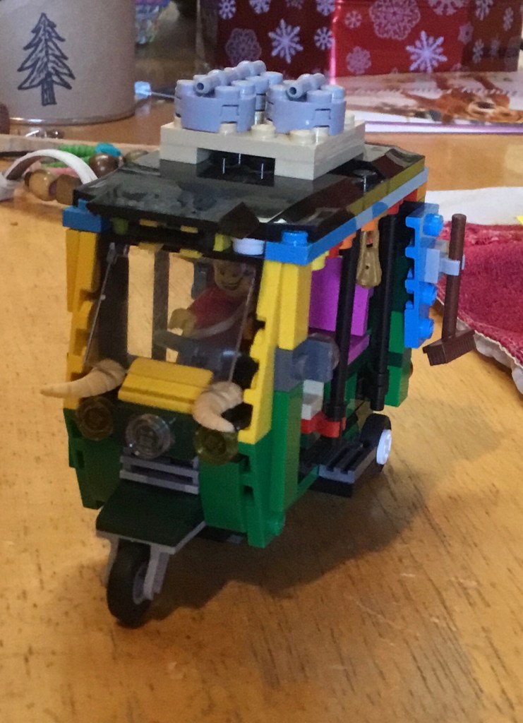 A Lego tuk tuk with tusks