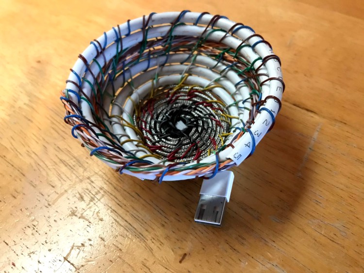 A small woven basket made by Sarah Batchelder from old repurposed wires.