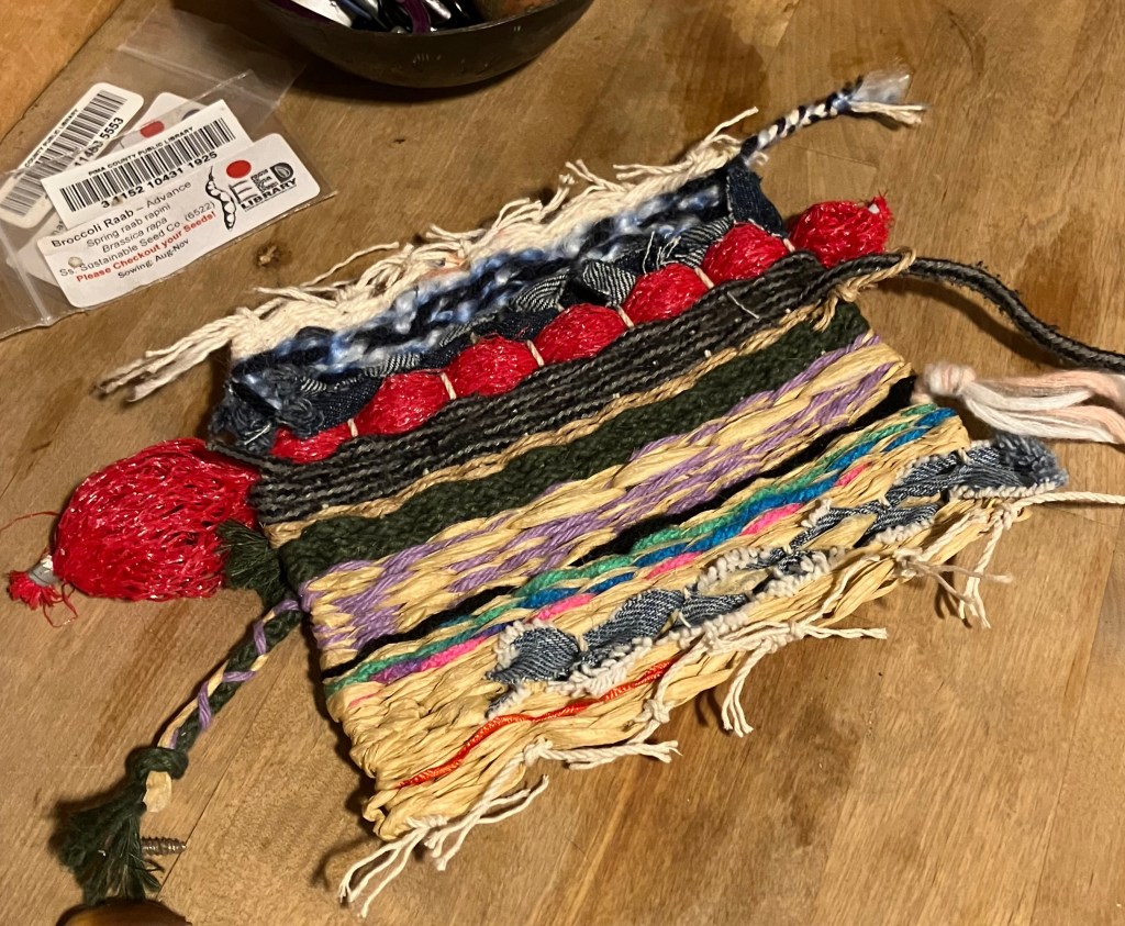 The finished mini weaving by Sarah Batchelderon a table.