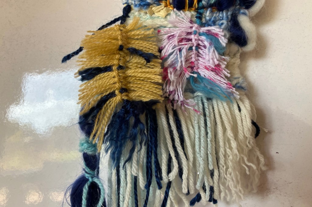 A close up on the bottom of a hand woven mini tapestry made by fiber artist Sarah Batchelder.