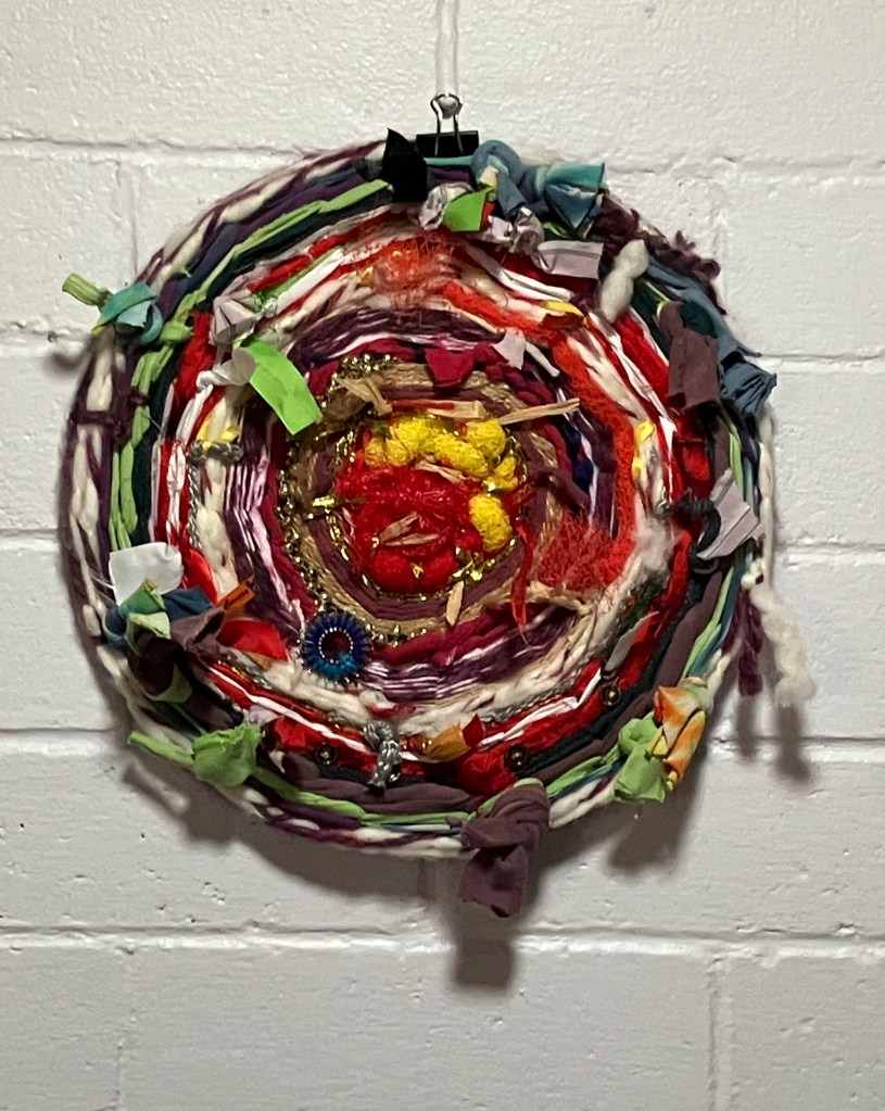 A circular weaving by Sarh Batchelder made mostly from repurposed fibers.