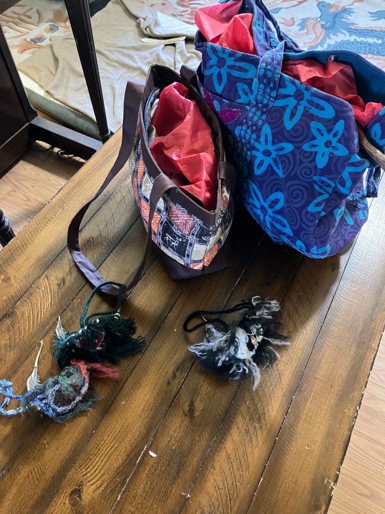 A couple of packed bags on a coffee table with a few decorations next to them.