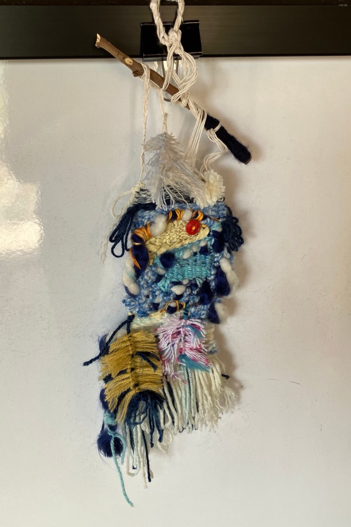 A mini hand woven wall hanging by fiber artist Sarah Batchelder.