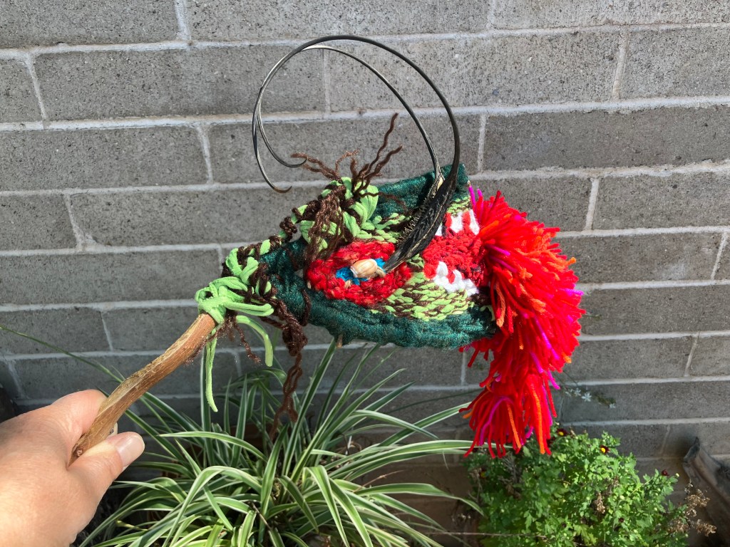 A handwoven dragon puppet branch weaving by Sarah Batchelder